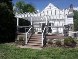 Timbertech PVC Brownstone deck with stone columns and white vinyl Pergola &#8211; Wayne PA