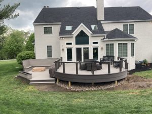 Timbertech PVC Coastline deck with Dark Hickory border, matching custom railings with stainless steel cable infill, curved front, custom bench &#038; planter box &#8211; Chadds Ford PA