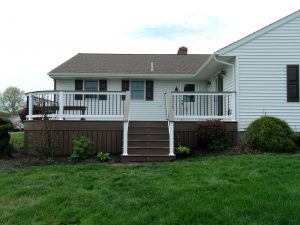 Timbertech PVC English Walnut deck with matching skirting and drink rail, curved front corner, and step lights &#8211; Barto PA