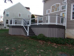 Timbertech PVC Brownstone deck with Kona border, white Vinyl rails with black aluminum balusters and a Kona drink rail, Brownstone skirting &#8211; Malvern PA