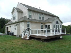 Timbertech PVC French White Oak deck with American Walnut border and drink rail, white vinyl railings with black aluminum balusters and post cap lights &#8211; Garnet Valley PA