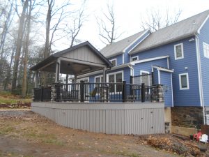 Timbertech PVC Coastline deck and skirting, black Timbertech Radiance railings, Pavilion roof and stone columns &#8211; Berwyn PA