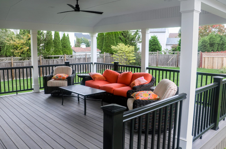 tan and black deck with black, orange, and white outdoor furniture