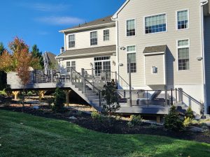 Timbertech PVC Boardwalk deck with Castle Gate border, black aluminum railings with horizontal  cable infill, outdoor kitchen &#8211; Newtown Square PA