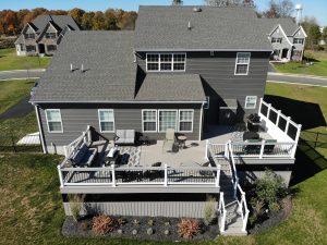 Timbertech PVC Slate Gray deck, white viny rails with black aluminum balusters and Slate Gray drink rail, privacy wall and custom skirting &#8211; Pennsburg PA