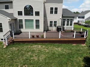 Trex Lava Rock deck with Tiki Torch border, black American series railing with White Vinyl posts &#8211; Glen Mills PA